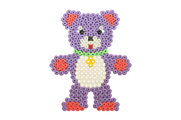 Handmade applique bear in an apron made of tubes isolated on white background