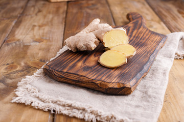 Ginger and lemon on a wooden background, Photo in a rustic style. Ingredients for warming and health drink. Alternative medicine. Free space for text