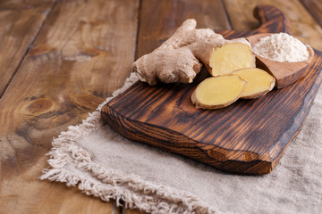 Ginger and lemon on a wooden background, Photo in a rustic style. Ingredients for warming and health drink. Alternative medicine. Free space for text