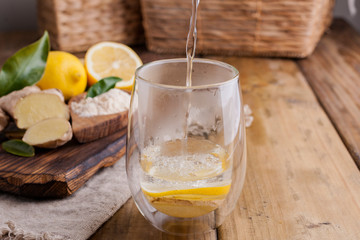 ginger, lemon and glass on a wooden background, Photo in rustic style. Ingredients for warming and health drink. Alternative medicine. Free space for text