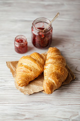 Freshly baked croissants on wooden rustic background. Tasty croissants with copy space