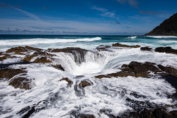 Thor's Well at Cape Perpetua near Yachats on the Oregon coastline. This natural phenomenon is a must see to any tourist visiting the sea side of Oregon.  The ocean waves rise and fall inside the rock