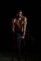 Fototapeta na wymiar Muscular male bodybuilder on black background