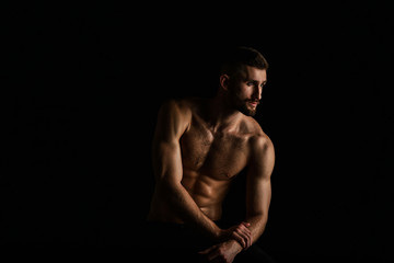 Fototapeta na wymiar Muscular male bodybuilder on black background