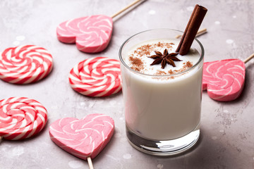 Glass of eggnog and candy cane.