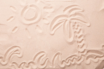 Palm and waves are painted in the sand.
