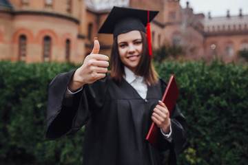 Education and people.Okay sign! Focus at woman with diploma! Near university!