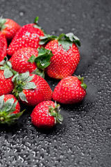 Fresh ripe strawberry with water drops closeup.