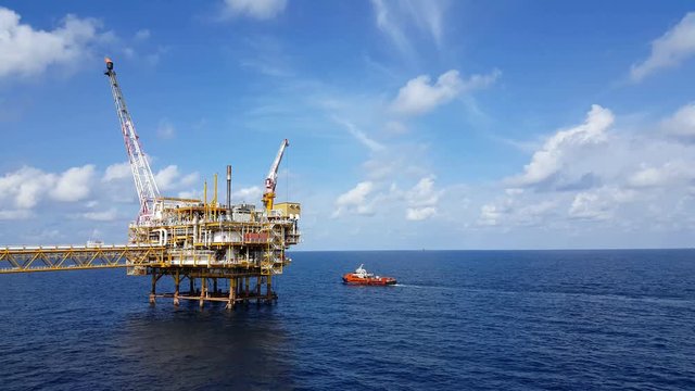 Songkhla, Thailand-February 08, 2019 : Red Supply boat transfer cargo to oil and gas industry and moving cargo from the boat to the platform. Boat is waiting transfer cargo and crews to platform.