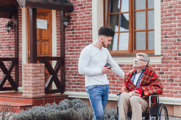 Invite of family! Son with his father holding coffe and talking with dad!