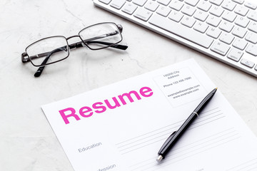 Review resumes of applicants set with keyboard and glasses white work desk background