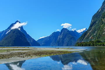 reflections of mountains in the water, milford sound, new zealand 35