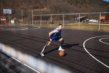 Basketball player doing stretching at street court
