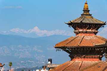Temple in Kathmandu with Himalaya mountains at background, Nepal