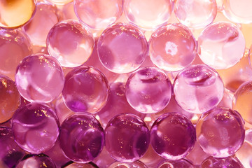 Abstract background with shiny water balls in violet and orange colors