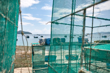 Lobster netting cages on sand beach in Vietnam