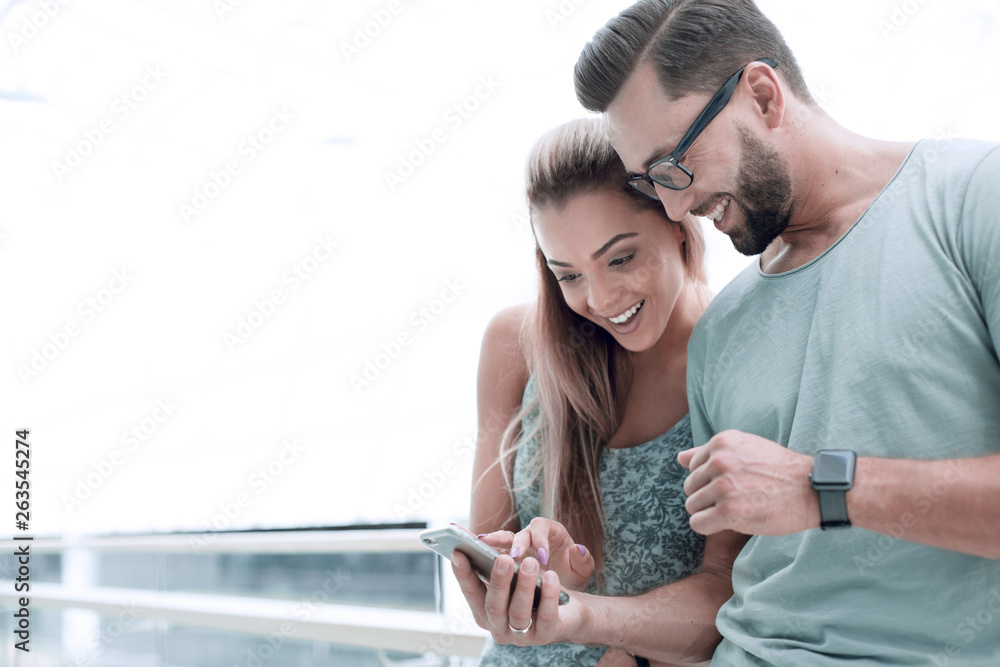 Wall mural close up.a couple in love discussing video on a smartphone