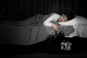 Little boy and monster under the bed. Bad dreams concept.