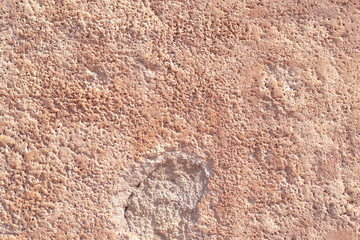 Textured plaster cement wall with cracks and stains