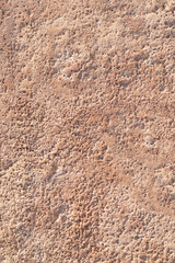 Textured plaster cement wall with cracks and stains