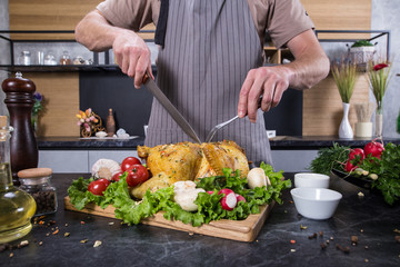 Tasty delicious food on wooden desk in kitchen. Grilled chicken or turkey with spices and fresh vegetables. Christmas or thanksgiving pay preparation