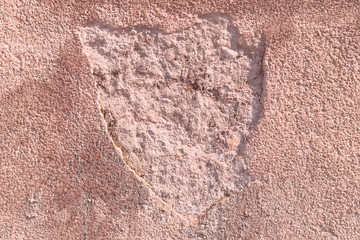 Textured plaster cement wall with cracks and stains