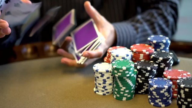 fancy spring of playing cards at gambling table with poker chips