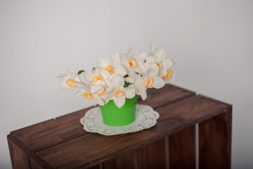white flowers in a vase on wooden table