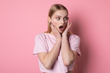 Fototapeta premium Waist up portrait of shocked and scared girl in stupor loking concerned and terrified raising hands, open mouth