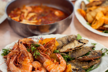 Sea food dishes in plates on the table