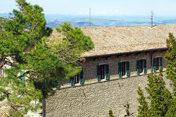 Fototapeta na wymiar Houses with tiled roofs in San Marino, UNESCO. The background