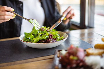 woman eating green healthy salad
