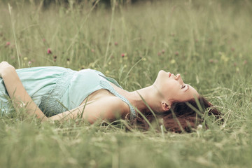 cute girl resting in a clearing on a hot summer day