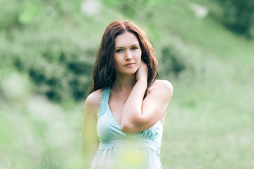 Fototapeta premium pensive young woman standing in summer Park.