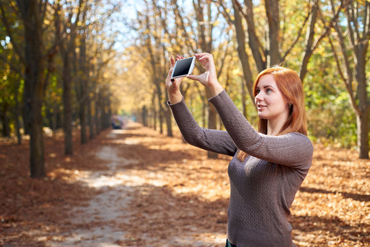 Beautiful girl takes pictures of herself on the phone
