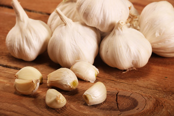 Garlic Cloves and Bulb on vintage wooden table.