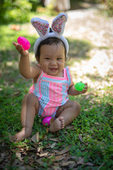 Baby girl with easter eggs