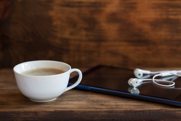 Digital tablet and a cup of coffee