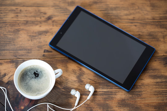 Digital tablet and a cup of coffee