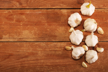 Garlic Cloves and Bulb on vintage wooden table. Top view. Place for text, copy space