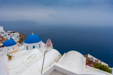 Fototapeta premium Panorama of the village of Oia and the caldera on a rare rainy day