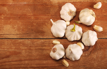 Garlic Cloves and Bulb on vintage wooden table. Top view. Place for text, copy space