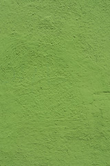 Wall painted in green. Bright green grungy background.