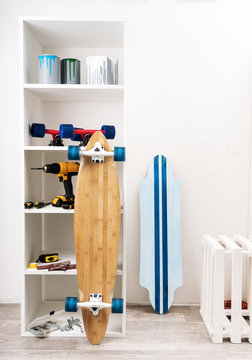 Mastrekskoy interior for mending skateboards and longborods. White cabinet with tools.
