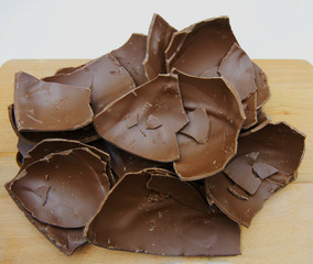 Broken chocolate Easter egg on a wooden table
