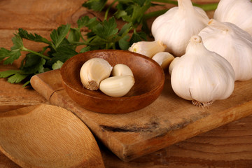 Garlic. sliced garlic, garlic clove, garlic bulb in wooden bowl place on chopping block on vintage wooden background.