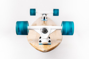 Wooden longborod with blue wheels on a white background.