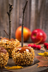 Caramel Apples on Wooden Background. Selective focus.