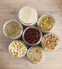 Top view of jars with an assortment of rice, beans and legumes