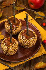 Caramel Apples on Wooden Background. Selective focus.